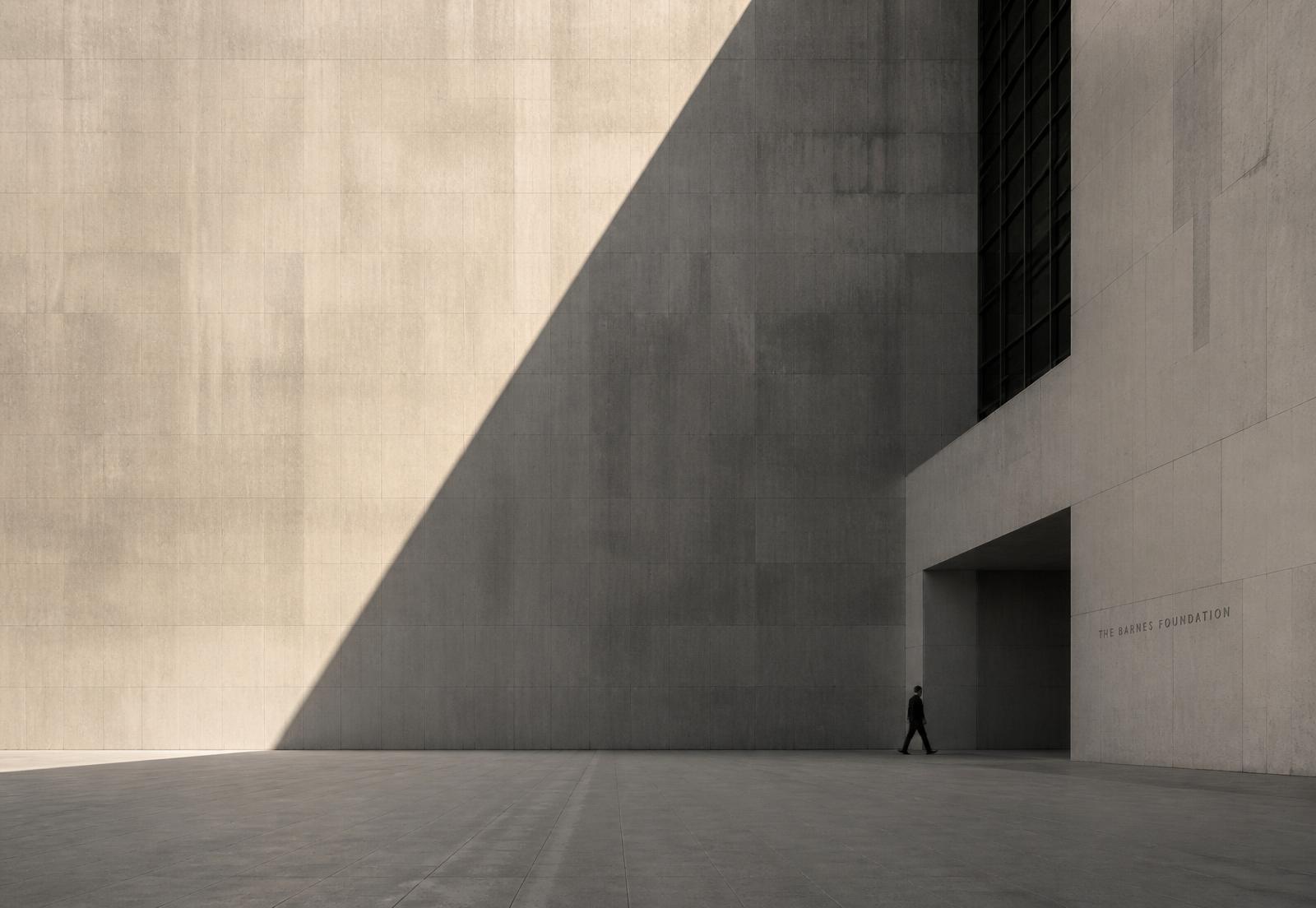 Monumental stone facade cut by a diagonal shadow